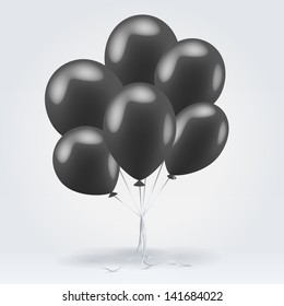 Bunch of black glossy inflatable balloons over light background