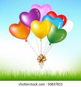 Bunch Of Colorful Heart Shape Balloons With Golden Bow Above Grass