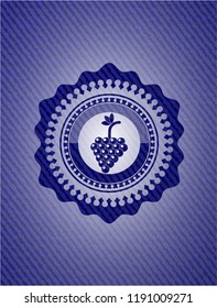 bunch of grapes icon inside badge with denim background