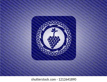 bunch of grapes icon inside badge with denim background