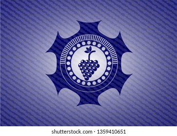 bunch of grapes icon inside badge with denim texture
