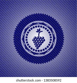 bunch of grapes icon inside badge with denim background
