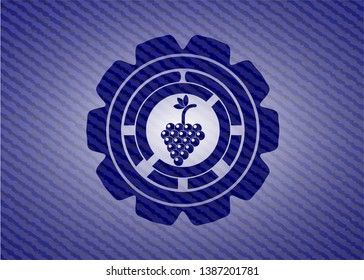 bunch of grapes icon inside badge with denim texture