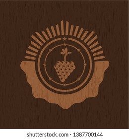 bunch of grapes icon inside badge with wooden background