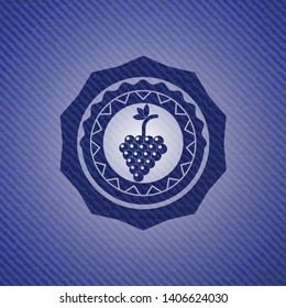 bunch of grapes icon inside badge with denim texture
