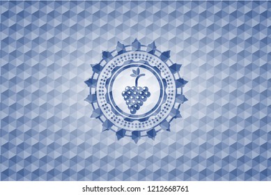 bunch of grapes icon inside blue emblem or badge with abstract geometric polygonal pattern background.