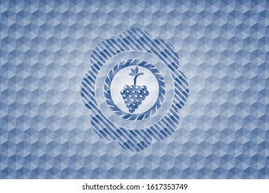 bunch of grapes icon inside blue badge with geometric pattern.