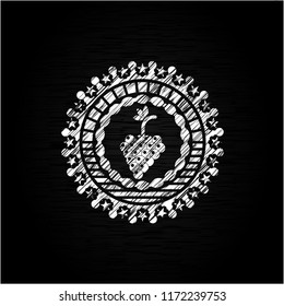 bunch of grapes icon inside chalkboard emblem written on a blackboard
