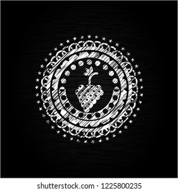 bunch of grapes icon inside chalkboard emblem written on a blackboard