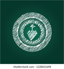 bunch of grapes icon inside chalkboard emblem written on a blackboard