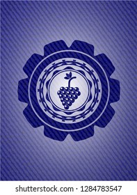 bunch of grapes icon inside emblem with jean texture