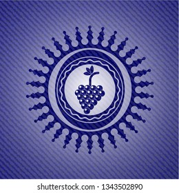 bunch of grapes icon inside emblem with jean background