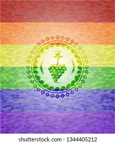 bunch of grapes icon inside emblem on mosaic background with the colors of the LGBT flag