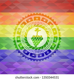 bunch of grapes icon inside emblem on mosaic background with the colors of the LGBT flag