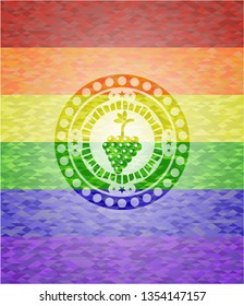 bunch of grapes icon inside emblem on mosaic background with the colors of the LGBT flag