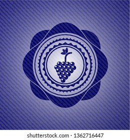 bunch of grapes icon inside emblem with denim high quality background