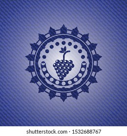 bunch of grapes icon inside emblem with denim texture