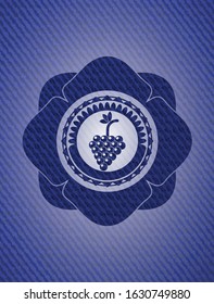bunch of grapes icon inside emblem with jean texture