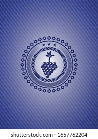 bunch of grapes icon inside emblem with jean texture