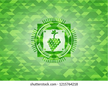 bunch of grapes icon inside green emblem. Mosaic background