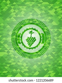 bunch of grapes icon inside green emblem with triangle mosaic background