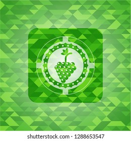 bunch of grapes icon inside green mosaic emblem