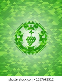 bunch of grapes icon inside green emblem with mosaic ecological style background