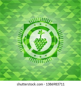 bunch of grapes icon inside green emblem with mosaic background