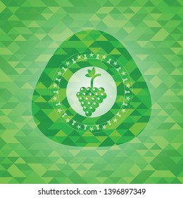 bunch of grapes icon inside green mosaic emblem