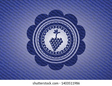 bunch of grapes icon inside jean or denim emblem or badge background