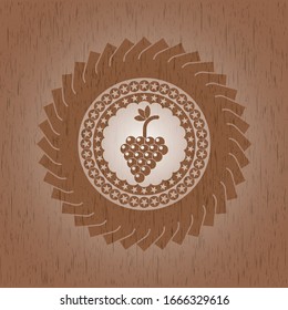 bunch of grapes icon inside realistic wood emblem