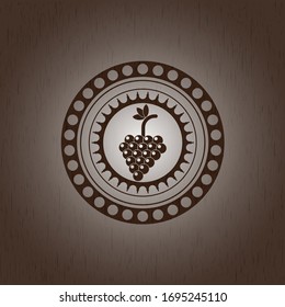 bunch of grapes icon inside realistic wooden emblem