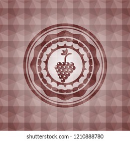 bunch of grapes icon inside red seamless badge with geometric pattern background.