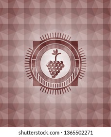 bunch of grapes icon inside red seamless emblem with geometric pattern.