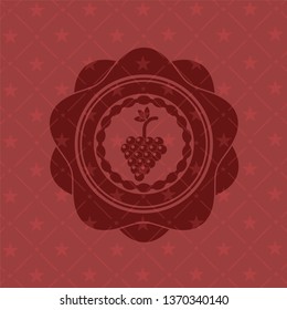 bunch of grapes icon inside red emblem