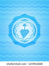bunch of grapes icon inside water concept style badge.