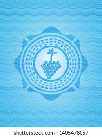 bunch of grapes icon inside water wave representation style badge.