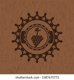 bunch of grapes icon inside wooden emblem