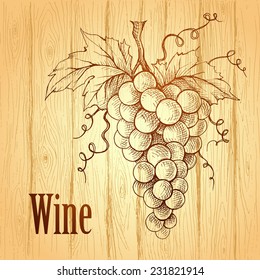 Bunch of grapes on wood background. Wine label. 