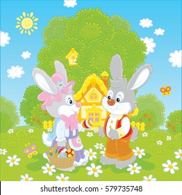 Bunnies with a basket of painted eggs in front of their small house on Easter day