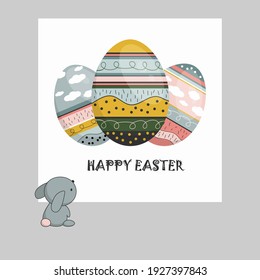 Bunny looks at Easter card. Three colorful eggs with phrase Happy Easter