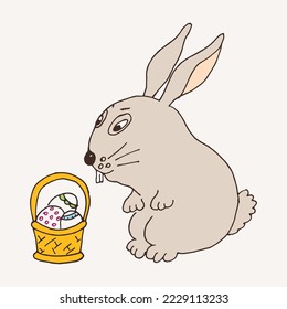 Bunny rabbit with Easter eggs in a wicker basket