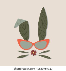 Bunny rabbit face drawing of natural green leaves with glasses on ecru background. Happy easter bunny.