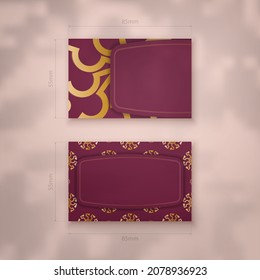 Burgundy business card with abstract gold ornament for your business.