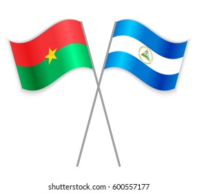 Burkinabe and Nicaraguan crossed flags. Burkina Faso combined with Nicaragua isolated on white. Language learning, international business or travel concept.