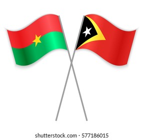 Burkinabe and Timorese crossed flags. Burkina Faso combined with East Timor isolated on white. Language learning, international business or travel concept.