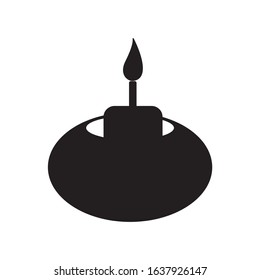 burning candle in candle in candlestick icon