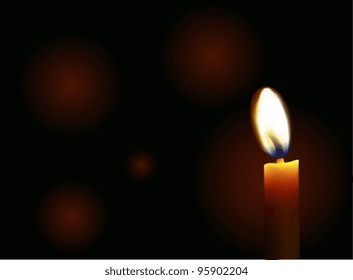 Burning candle on a black background