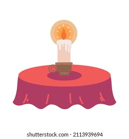 burning candle on table isolated