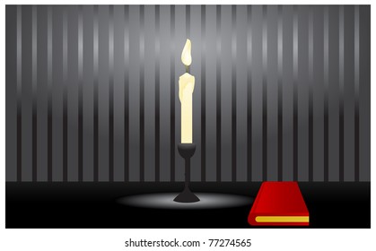 Burning candle standing on a table with the nearby red book